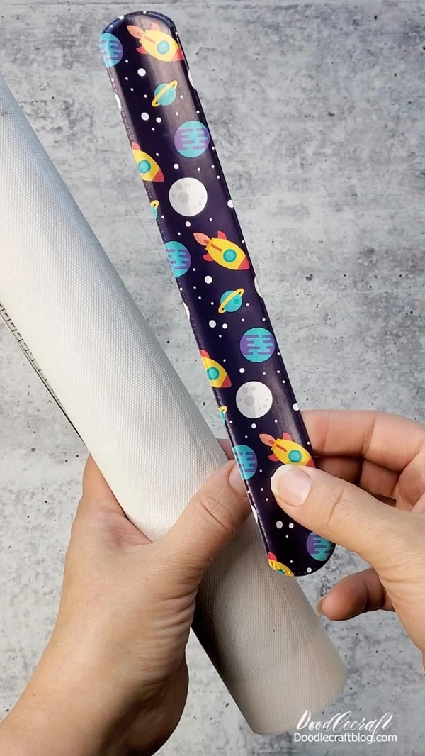 Simply use a slap bracelet around the rolled up diamond art to hold the roll in place.  (slap bracelets for days)