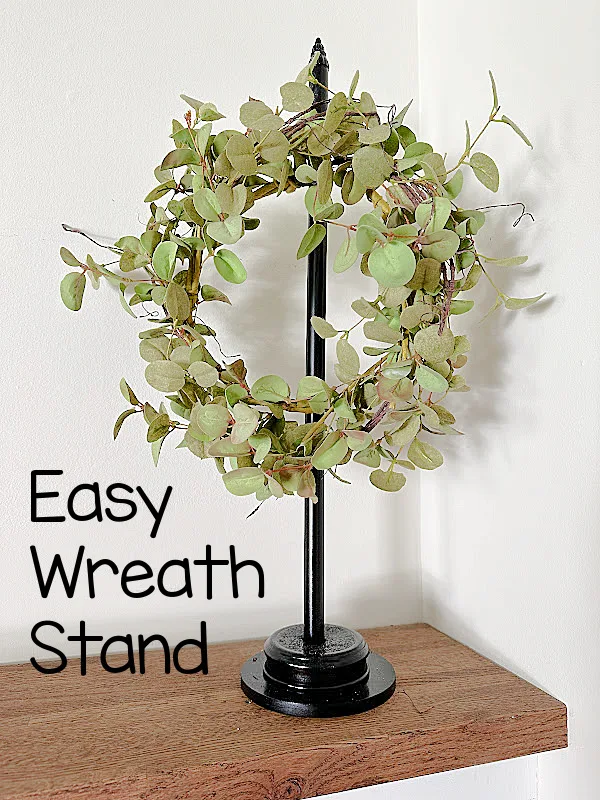 wreath stand with olive wreath and overlay pin