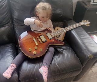 Rosie strums my guitar