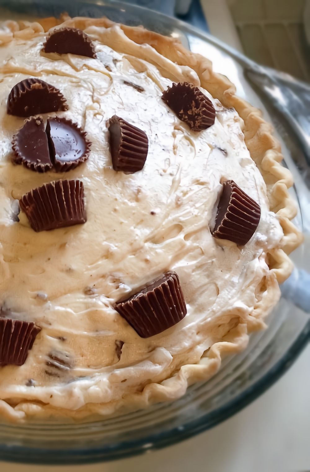 No Bake Reeses Cup Peanut Butter Pie ~ It's as easy as whipping up peanut butter with cream cheese and whipping cream. Mix in some Mini Reeses Cups. Refrigerate. And serve.