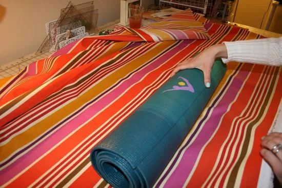 Before I cut the fabric, I measured the size of the yoga mat in relation to the fabric.