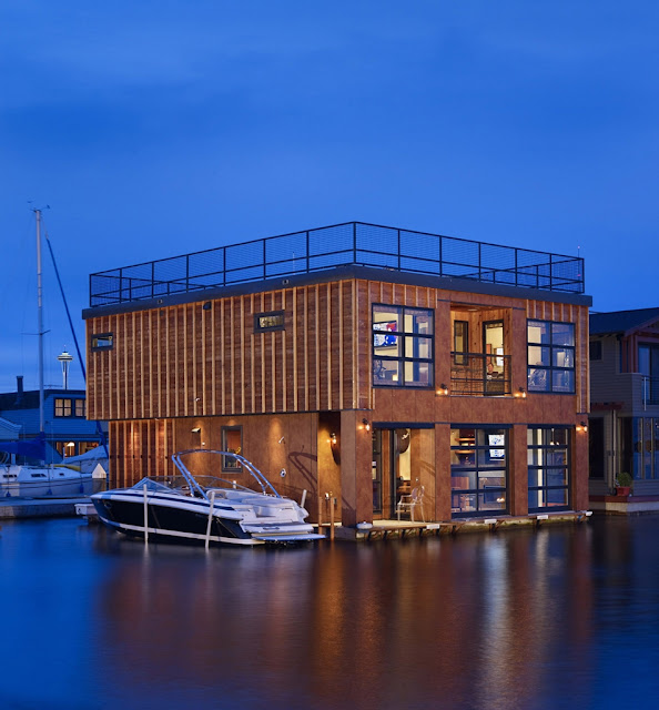 Photo of floating home at sunset with high speed boat parked next to it