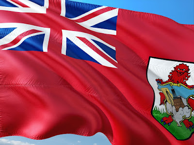 Bermuda's flag flapping in the wind against a blue sky background