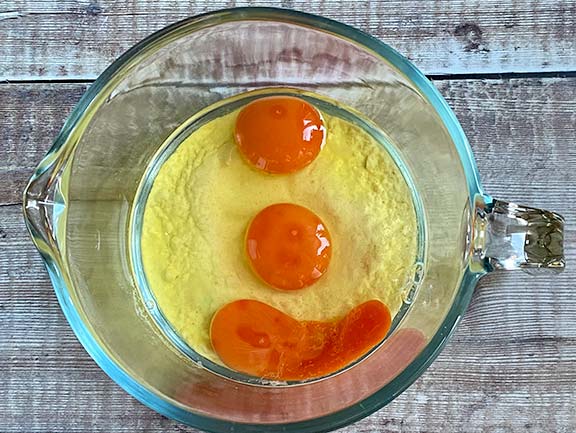 Flour and eggs in a jug.