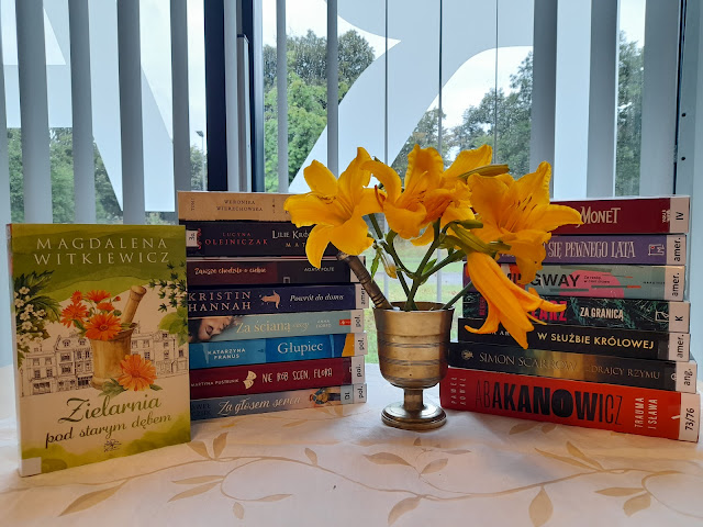 Nowe książki, przed którymi stoi moździerz z liliami.