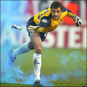 Carlo Cudicini disposing of a flare that has been thrown onto the pitch.