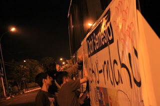 lagi nempel banner di bus