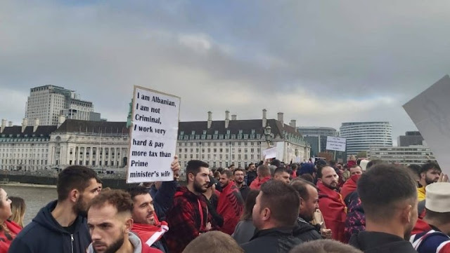 Albanians with banners protesting in England