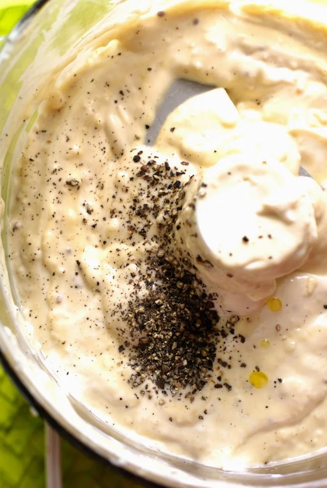 Fresh cracked black pepper is added to Homemade Creamy Caesar Salad Dressing.