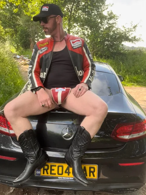 6/6 Leather thong Cowboy Boot Wearing chilling on hood of car smoking a cigarette