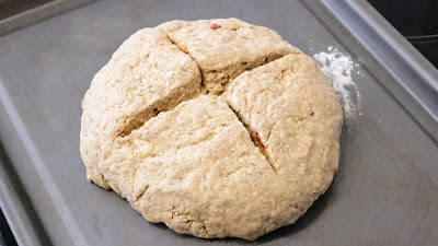 Irish vegan Soda Bread dough with a cross cut in on a metel baking sheet