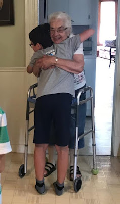 Grandmother hugging grandson tight
