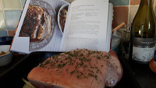 Pork joint ready for the oven with thyme and salt rubbed into the scored skin