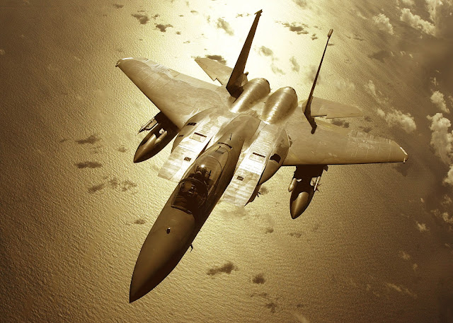 F-15C over the pacific in golden glow.