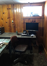 Studio Makeover Before - painting knotty pine panneling