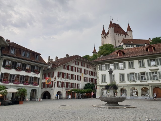 Rathausplatz or City Hall Square with Thun Castle perched on a hilltop.