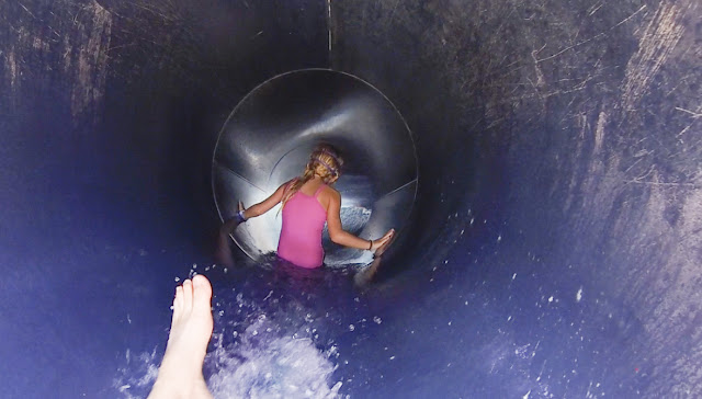 Little girl slides down water slide at Adventure Landing