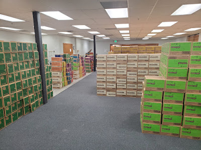Stacks of cases of Girl Scout cookies in a large room