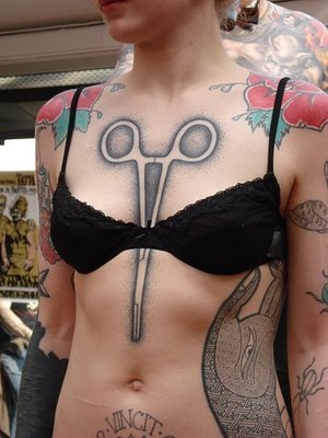 Middle Of Breast Tattoos