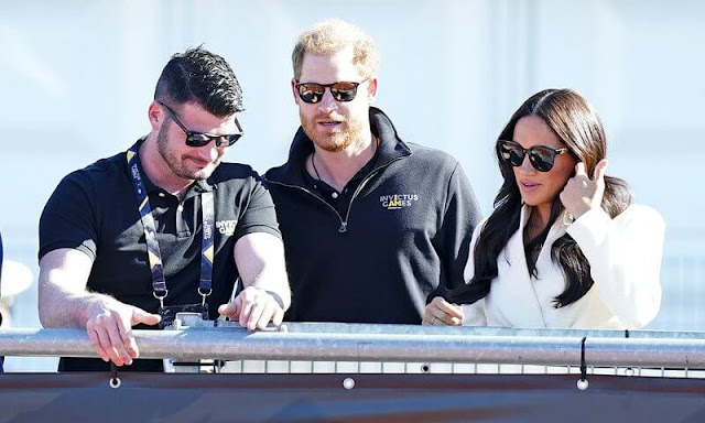 Meghan Markle wore a white belted jacket from Brandon Maxwell Fall-2022 collection. Prince Harry met athletes and organisers