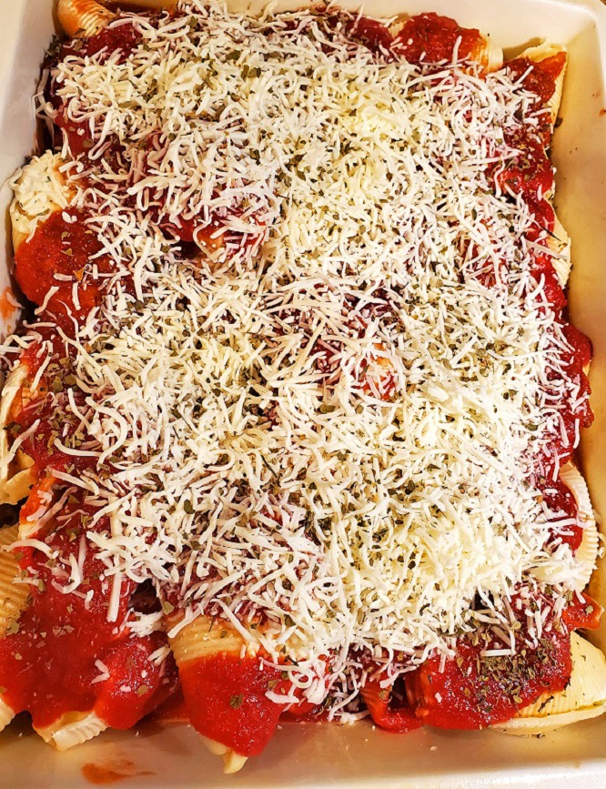 this is a casserole of stuffed shells with ricotta cheese mozzarella and tomato sauce in a large casserole pan by Revol