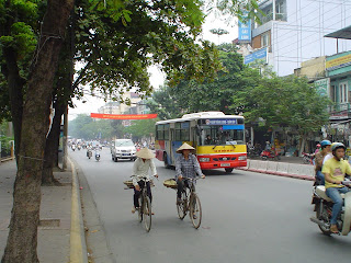 Vietnamese women riding bicycles with Vietnamese Hat