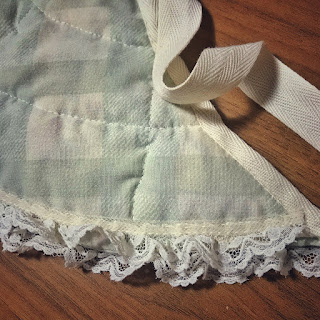 green-and-white checked bustle pad with lace edging