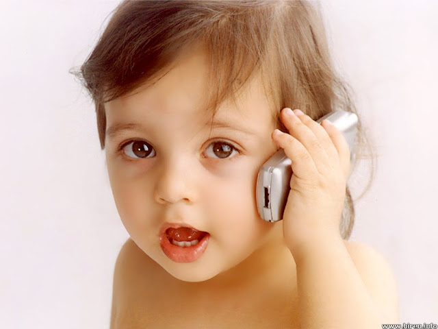 cute baby picture handing a cellphone calling papa