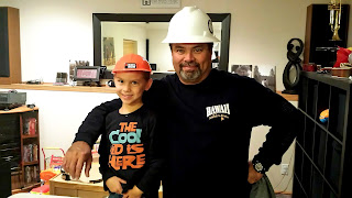 father and son wearing construction helmets