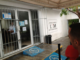 Waiting in the rain outside the Immigration Office in Cancun