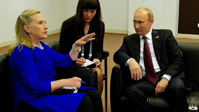 Hillary Clinton sitting with Putin