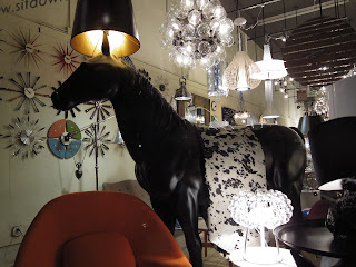 full-sized horse sculpture in store window