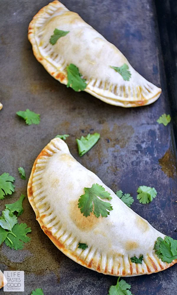 Buffalo Chicken Empanadas | by Life Tastes Good combines all the spicy deliciousness of a favorite appetizer into a handy pastry you can eat without getting all the sticky goodness all over your hands! These empanadas are baked to crispy perfection and make a tasty dinner or even a fun party appetizer. #LTGRecipes