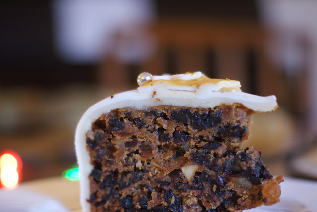 slice of christmas cake side shot showing almonds and fruit