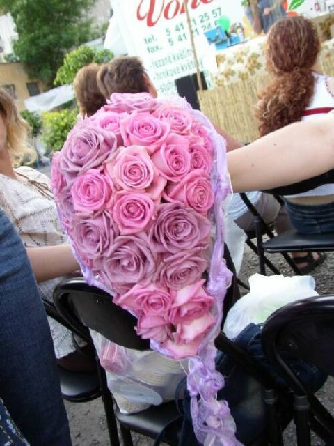 Beautiful cascading bridal bouquet made up entirely of pink and purple roses 