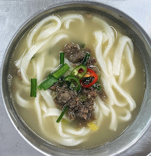 Korean knife-cut noodle soup with vegetables and beef