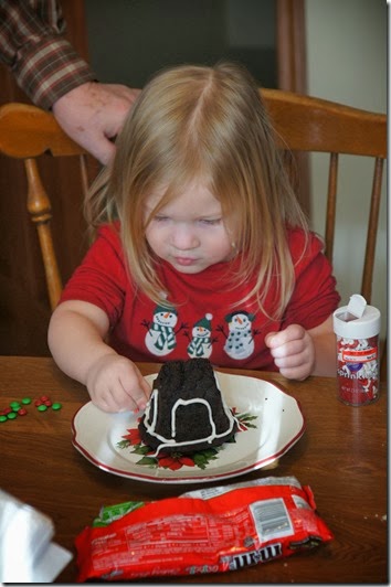 toddler decorating her gingerbread house