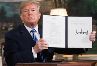 US President Donald Trump signs a document reinstating sanctions against Iran after announcing the US withdrawal from the Iran Nuclear deal, in the Diplomatic Reception Room at the White House in Washington, DC, on May 8, 2018. (Photo by SAUL LOEB / AFP) (Photo by SAUL LOEB/AFP via Getty Images)