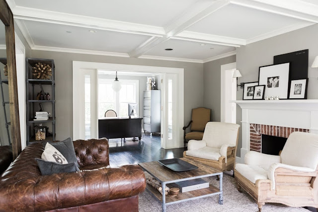 Modern farmhouse living room with fireplace and tufted leather sofa on Hello Lovely Studio