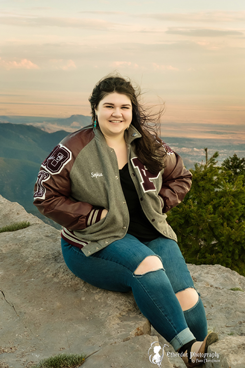 Professional senior photograph of a beautiful girl in the mountains