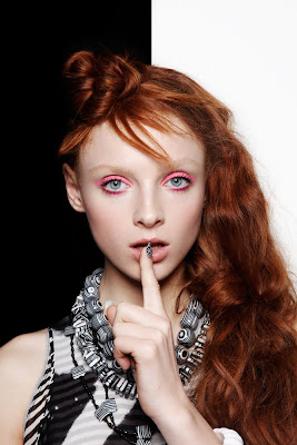 redhead model with topknot hair style, black and white accessories