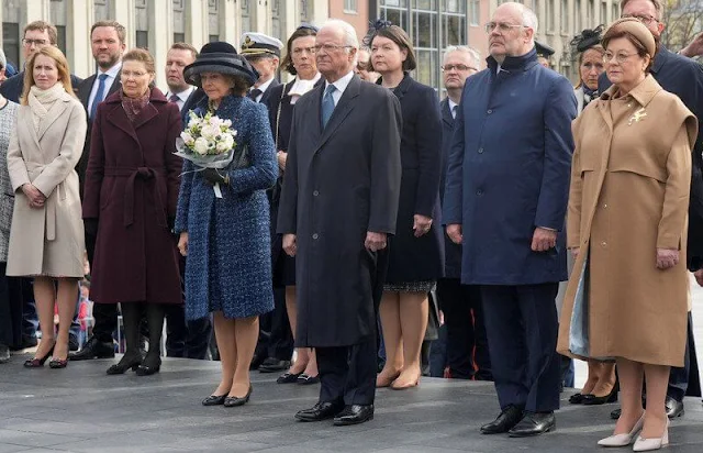 Queen Silvia wore a navy tweed coat, tweed jacket and navy tweed dress by Chanel. Mrs Sirje Karis and Prime Minister Kaja Kallas