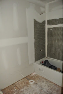 Picture of the hallway full bathroom as viewed through the doorway just after drywall installed