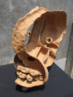 this expressionistic face had been done in the process of pinching clay, out of  clay  and the planes in making the images are juxtaposed and composed as a unite  , pleasure ti the sight to view it..