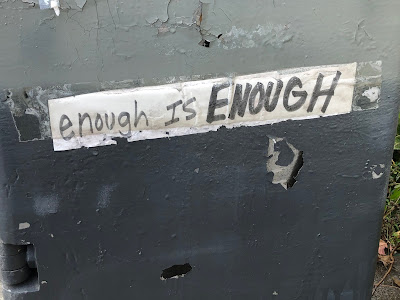 Sticker saying, "enough is ENOUGH"