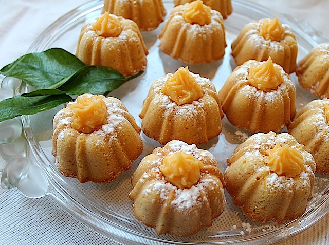 Food Lust People Love: Citrus Lust Mini Bundt Cakes are topped with homemade lemon curd for a gorgeous and deliciously sweet and tart dessert that will delight fancy guests and family alike.