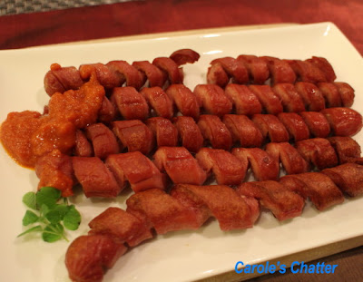 Spiral cut frankfurter sausages with curry ketchup