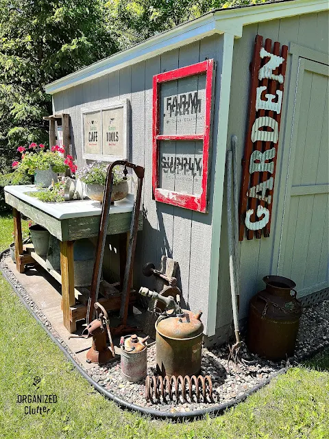 Photo of junk garden shed plantings and decor.