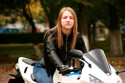 A Cute Girl Wearing Black Leather Jacket Riding Motorbike