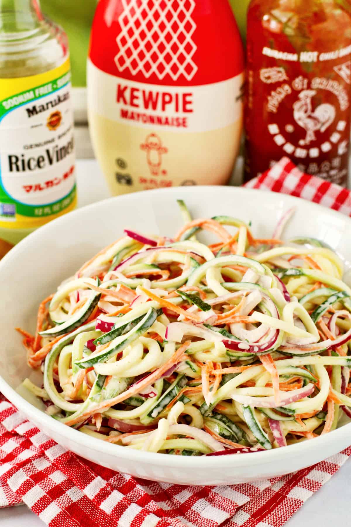Zucchini Slaw with Kewpie mayonnaise bottle in the background.